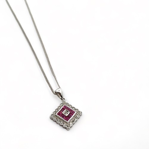 20 - A ruby and diamond 18ct white gold pendant necklace. Hallmarks to pendant and 18