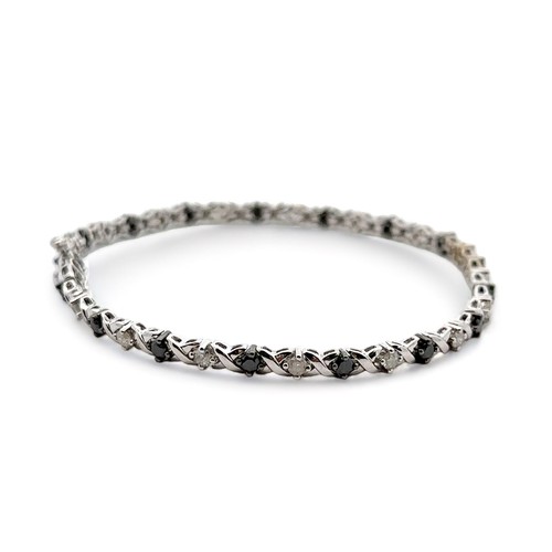 7 - A 9ct white gold diamond and haematite bracelet. Length approx 20cm. Weight 9.45g.


Please see the ... 