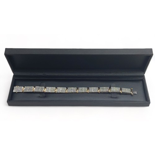 49 - A 9ct gold and diamond bracelet. Each of the eleven main links is set with 35 diamonds.  Length appr... 