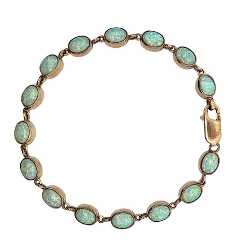 15 - Blue opal line bracelet stamped 9ct. Length approx 19cm. Weight 9.9g.

Please see the buyer's terms ... 