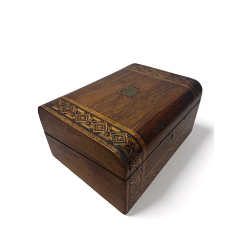 287 - A wooden writing box inlaid with various woods, containing glass inkwell. Length 29.8cm