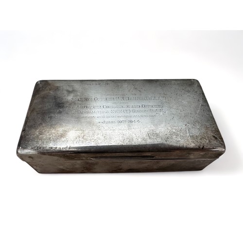 145 - A silver cigarette box with wooden interior and  marks for London 1942. Inscription on lid. Length 1... 