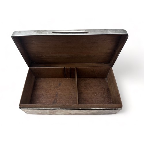 145 - A silver cigarette box with wooden interior and  marks for London 1942. Inscription on lid. Length 1... 