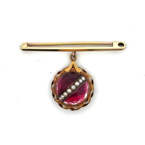 59 - A bar brooch with a red cabochon and seed pearl pendant in a twist surround mount suspended from it.... 