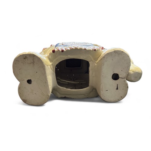 284 - A painted ceramic elephant design garden seat. Approx. 50 x 46 x 24cm.  There is a small crack to th... 