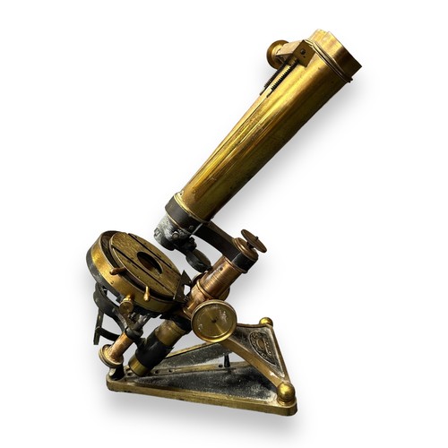 185 - R & J Beck of London, a 19th Century brass binocular microscope, standing upon a triangular-shaped f... 