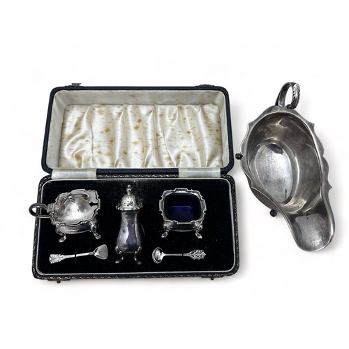 142 - A silver sauce boat by Kirwan & Co Ltd, Birmingham 1948, and a cased silver cruet set by William Suc... 