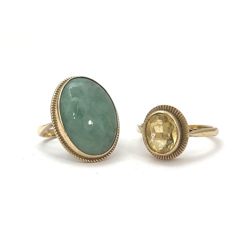 5 - Two hallmarked 9ct gold rings. A ring set with an oval jade cabochon size N, and a yellow quartz rin... 