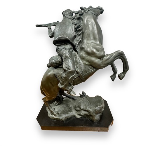 383 - Contemporary bronze effect sculpture of a Gunman on horseback, signed to mould Kamiko. Height 40cm.