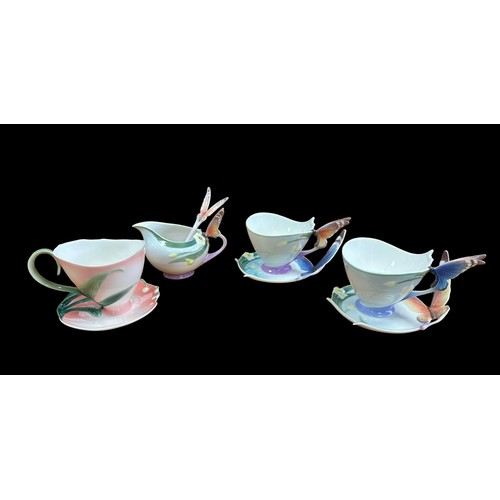 285 - Franz porcelain Butterfly and flower collection with tea pot, three tea cups with saucers, one with ... 