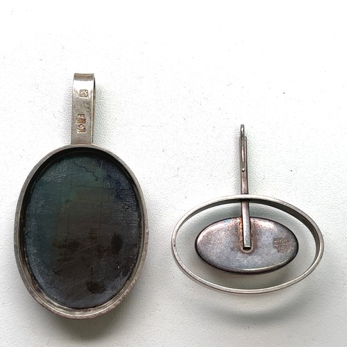 85 - Two Scandinavian silver and gem set pendants, a labradorite stone pendant with marks for the Finnish... 