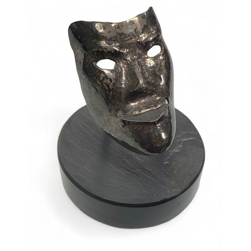 370 - Small unmarked white metal smiling mask metalwork sculpture stood on a round base. Height 9cm, diame... 