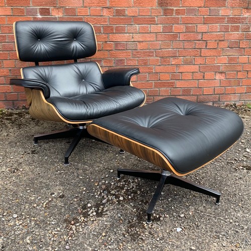 376 - After Charles and Ray Eames lounge chair and ottoman, black leather and moulded plywood with metal f... 