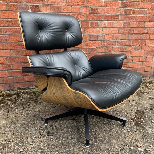 376 - After Charles and Ray Eames lounge chair and ottoman, black leather and moulded plywood with metal f... 