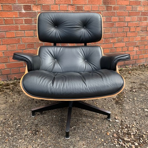 376 - After Charles and Ray Eames lounge chair and ottoman, black leather and moulded plywood with metal f... 