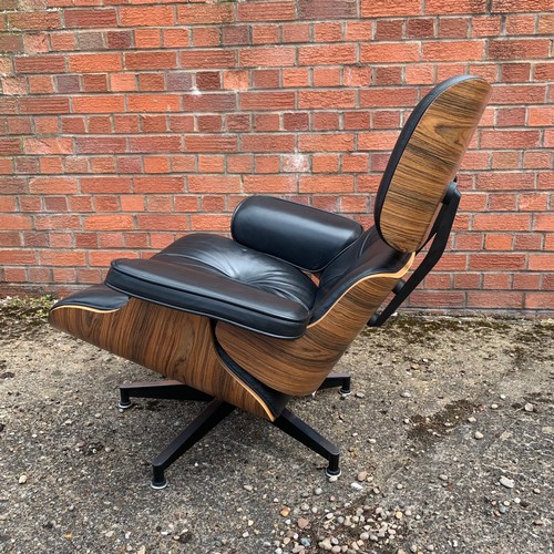 376 - After Charles and Ray Eames lounge chair and ottoman, black leather and moulded plywood with metal f... 