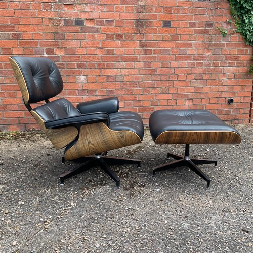 376 - After Charles and Ray Eames lounge chair and ottoman, black leather and moulded plywood with metal f... 