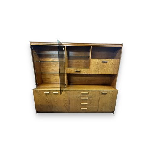 475 - A large mid-Century display unit, 4 central drawers and 3 cupboards to base, double glazed display c... 