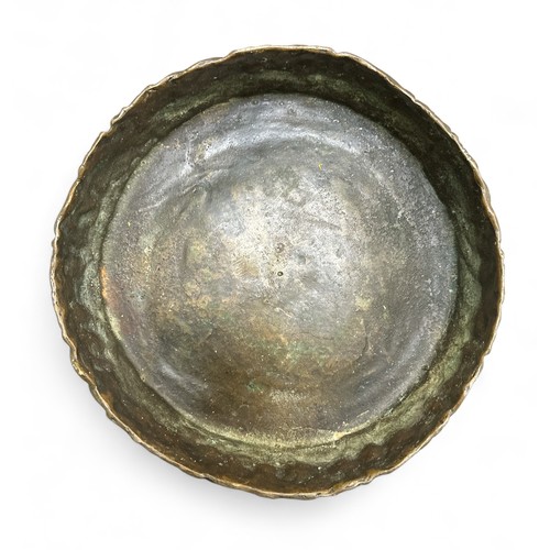 255 - A heavy embossed bronze tray or large dish, diameter approx. 23cm.