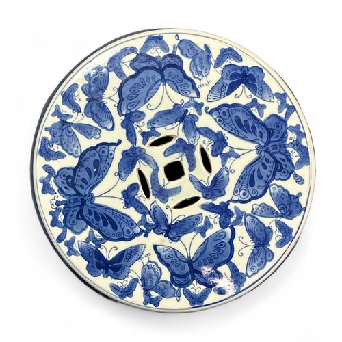 306 - Chinese ceramic garden seat / stool with blue and white butterfly surround pattern. Height 45cm, dia... 