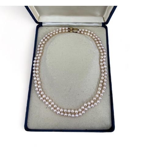 71 - A cased double cultured pearl necklaces with clasp stamped 375. Can be detached to form two single s... 