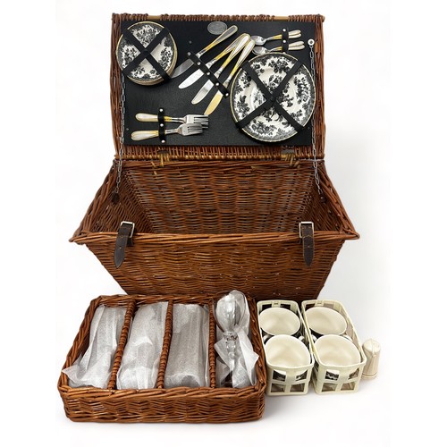 291A - A vintage Brexton wicker picnic hamper for four people. Approx 54cm x 36cm x 28cm.