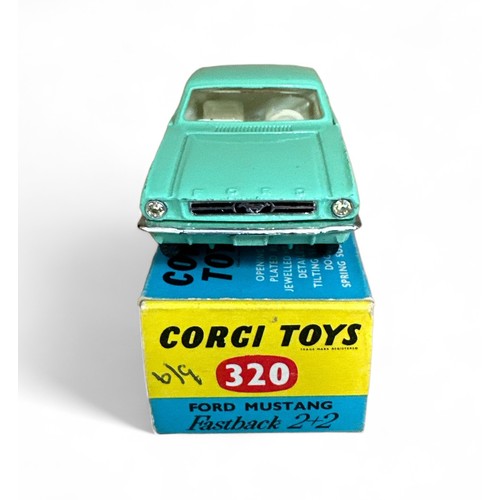 130 - Corgi Ford Mustang 2+2 No. 320, mint green, white interior, Corgi figure on rear shelf and wire whee... 