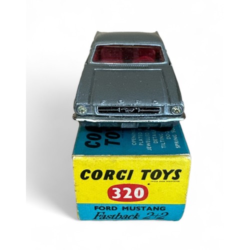 131 - Corgi Ford Mustang 2+2 No. 320, metallic silver, red interior, Corgi figure on back shelf and wire w... 