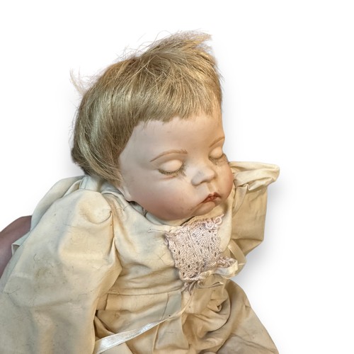 469 - Modern doll & toy pram, doll realistic dressed with maker's marks to back of head 