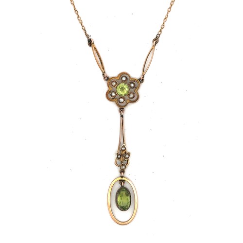 16 - An Art Nouveau peridot and seed pearl daisy pendant necklace. The daisy is comprised of a central ro... 