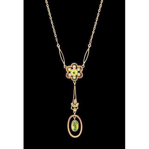 16 - An Art Nouveau peridot and seed pearl daisy pendant necklace. The daisy is comprised of a central ro... 