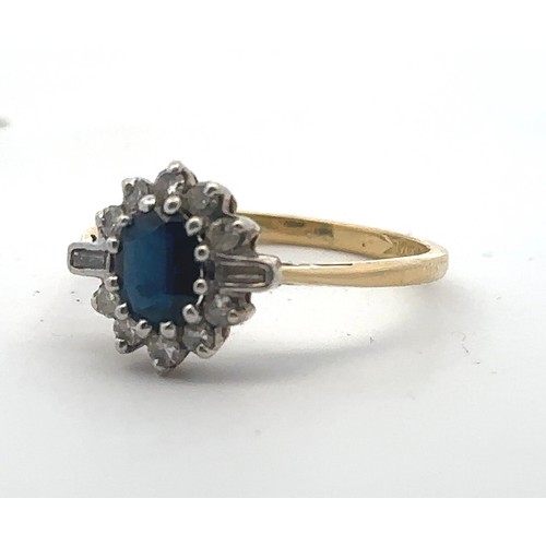 31 - An 18ct gold, sapphire and diamond cluster ring. Central oval sapphire surrounded by baguette and ro... 