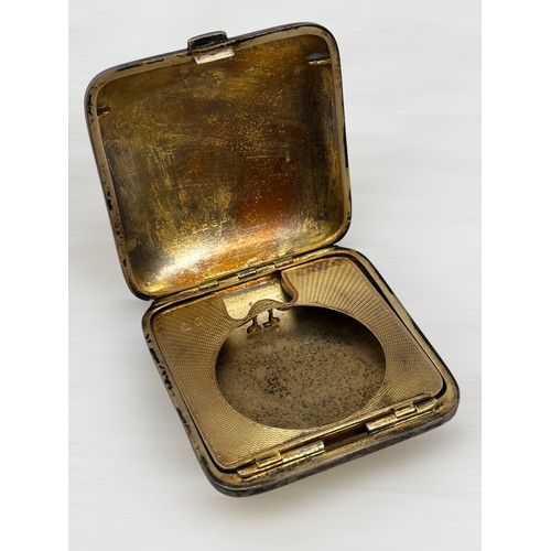 73 - A silver and double sided enamel compact by Henry Matthews, Birmingham 1929. Small area of damage to... 