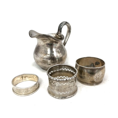 89 - A silver cream jug with Russian marks (840 silver) and three silver napkin rings. Total weight 206g.