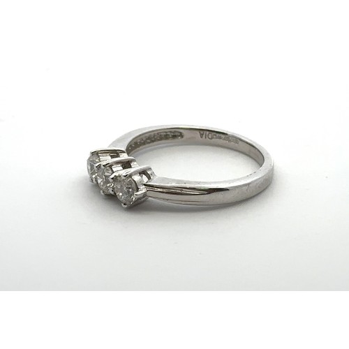 33 - An 18ct gold three stone diamond ring, size L.  Total diamond weight stamped on ring as 0.5ct. Spons... 