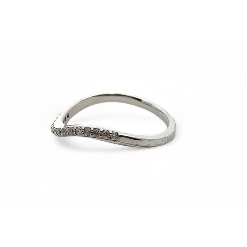 49 - A 9ct white gold and diamond wave shaped half eternity ring, size P. Sponsor CH, London assay mark. ... 