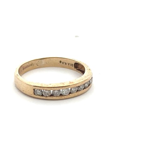 46 - A 9ct gold and diamond ring, set with 8 round brilliant cut diamonds in a row. London import hallmar... 