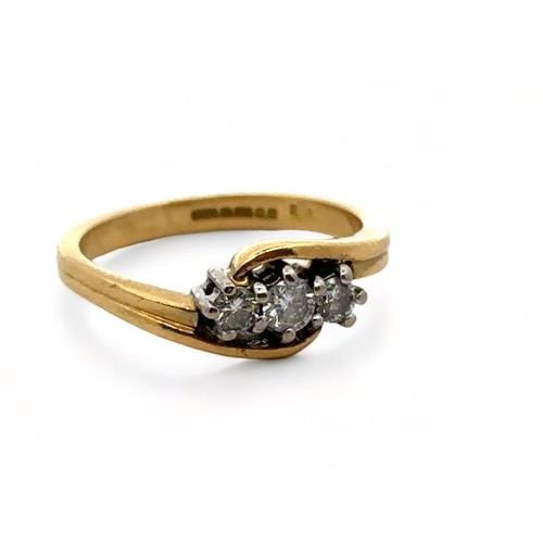 47 - An 18ct yellow gold three stone diamond ring, size J. Estimated diamond weight 0.24ct. London 2000 h... 