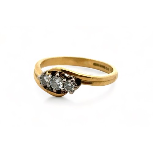 47 - An 18ct yellow gold three stone diamond ring, size J. Estimated diamond weight 0.24ct. London 2000 h... 