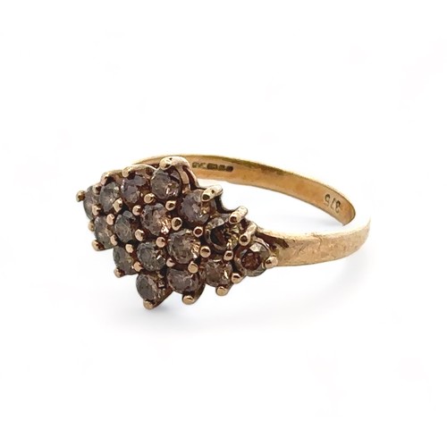 48 - A 9ct and gold diamond cluster ring set with 16 round cut champagne diamonds in a rhombus form, size... 