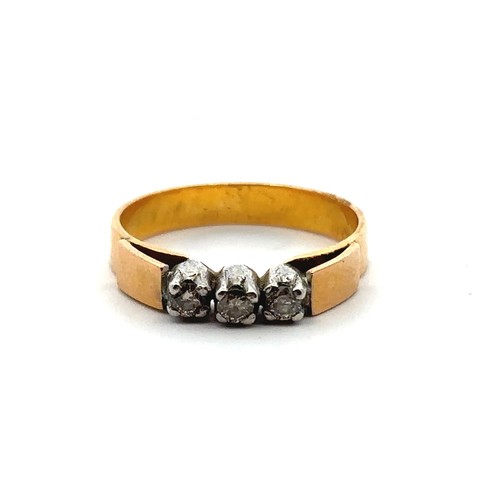 36 - Unmarked yellow metal and three stone diamond ring. Estimated total diamond weight 0.15ct. Weight 3.... 