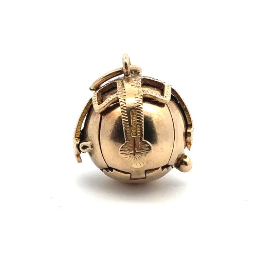 18 - A hallmarked 9ct gold Masonic orb. The orb pendant opening out into the form of a cross which is eng... 