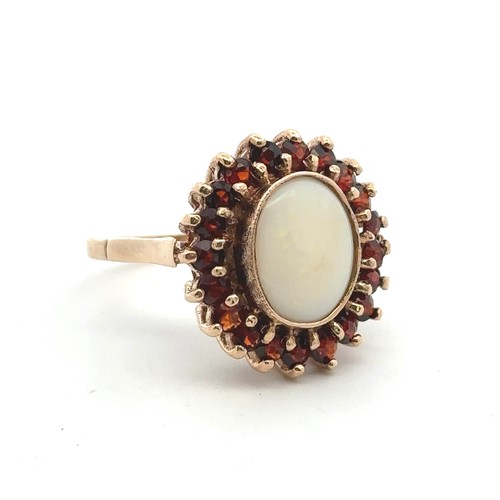 2 - A 9ct yellow gold opal and garnet cluster ring. Size P. Weight 6.42g.