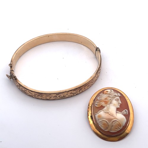 5 - A shell cameo brooch depicting a lady in profile, stamped 9ct. Length 37mm. Weight 5.48g.  And a 9ct... 