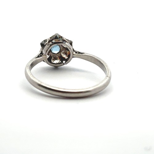 25 - An aquamarine and diamond flower ring stamped PLAT. Size L. Estimated diamond weight 0.36ct. Weight ... 