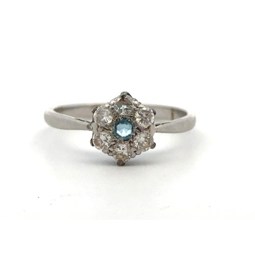 25 - An aquamarine and diamond flower ring stamped PLAT. Size L. Estimated diamond weight 0.36ct. Weight ... 