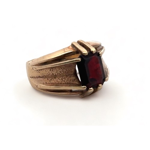 4 - A men's 9ct gold and garnet ring, size U. Birmingham hallmarks.