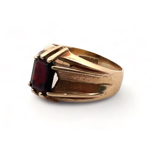 4 - A men's 9ct gold and garnet ring, size U. Birmingham hallmarks.