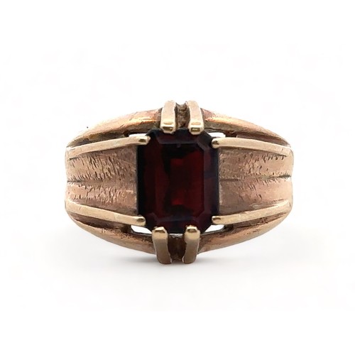 4 - A men's 9ct gold and garnet ring, size U. Birmingham hallmarks.