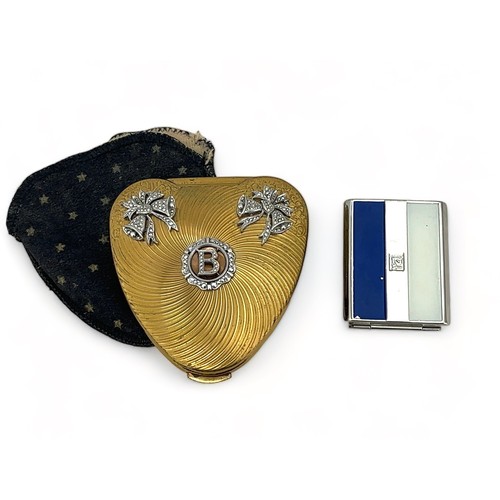 55 - Two compacts. A heart shaped gold-toned Kigu compact with white metal and marcasite decoration and w... 